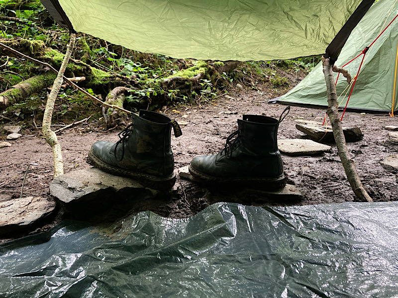muddy boots on rocks in wales, in a forest close to barmouth and fairbourne